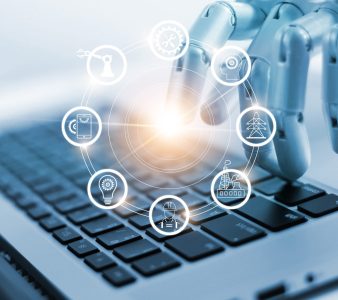 Hand of robotics connecting to industrial network connection on laptop. Artificial intelligence. Futuristic technology and manufacturing concept.